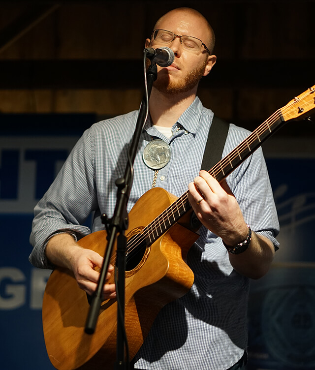 Matt McEuen Playing Guitar at Mic Matt McEuen Playing Guitar at Mic